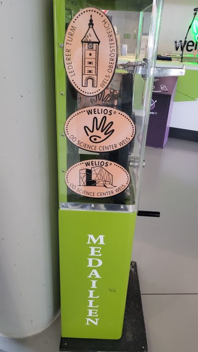 Souvenirmünze – Motiv von Münzautomat Welios - OÖ Science Center Wels (Weliospl. 1, 4600 Wels)