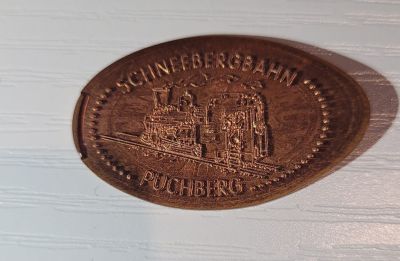 Souvenirmünze – Motiv von Münzautomat Schneebergbahn (Bahnstraße, 2734 Puchberg am Schneeberg)